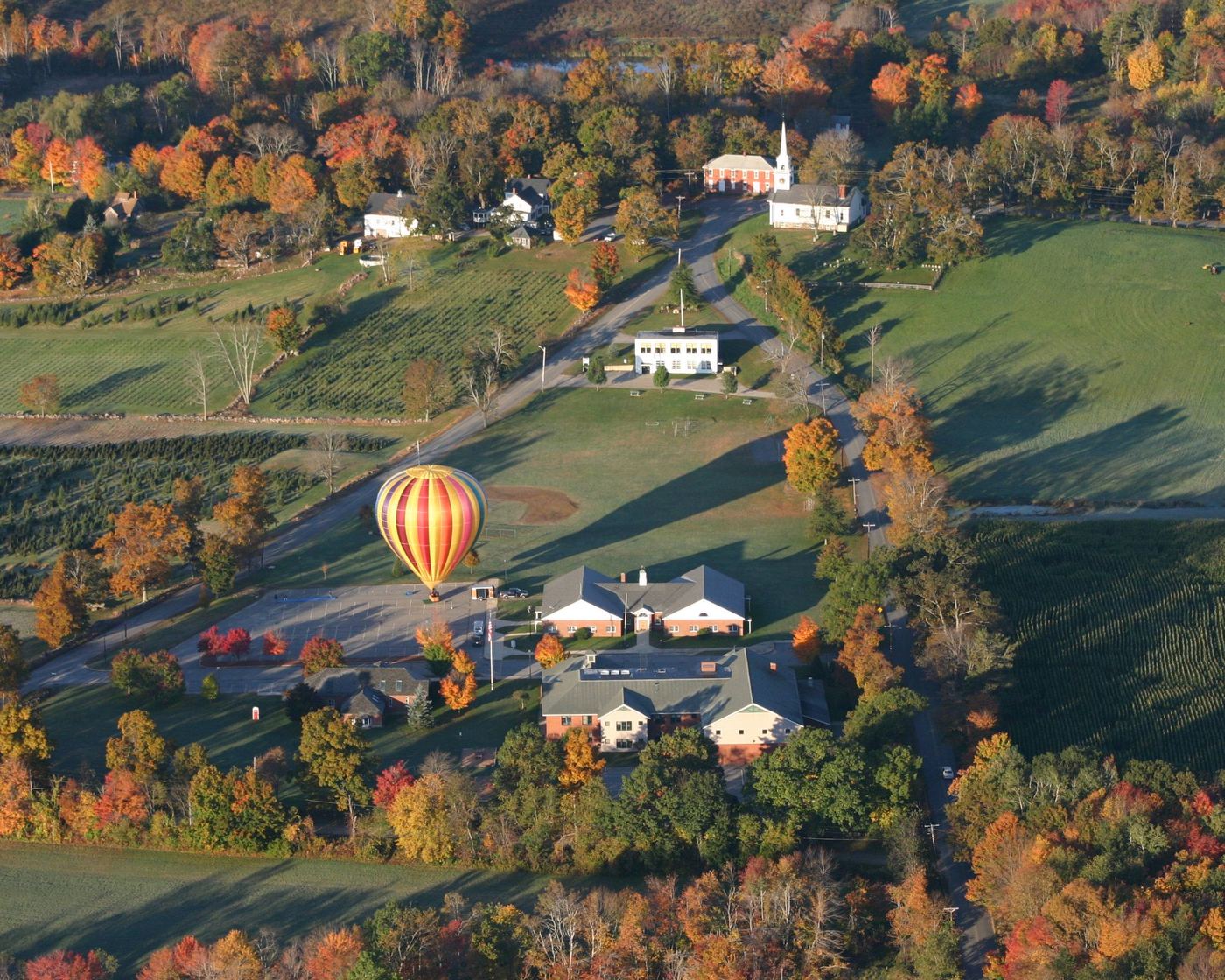 Hot air balloon over New Braintree town center in autumn